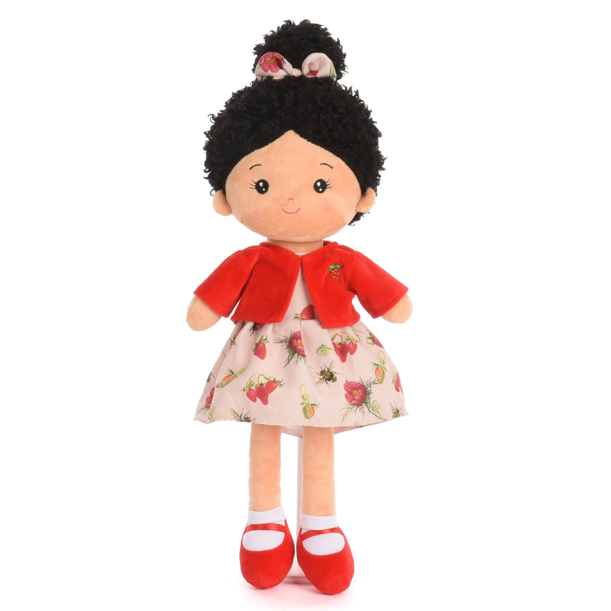 A plush doll with black curly hair, a red jacket, and a strawberry-patterned skirt, standing against a plain white background.