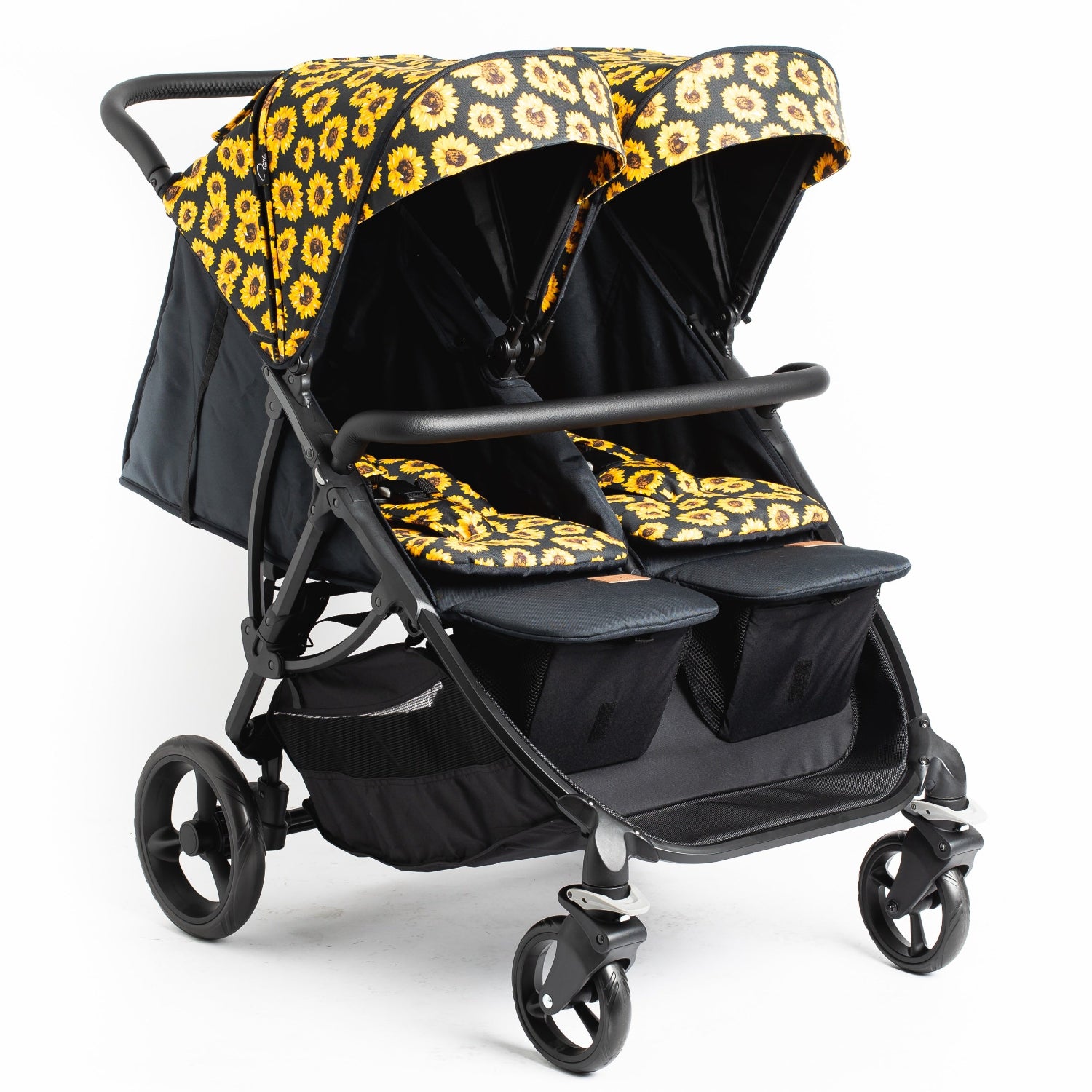 A Roma Gemini 2 double stroller in a sunflower pattern color pack, featuring large wheels, adjustable foot rests, and a black frame.